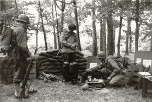 1993 Reenactment of Ardens Offensive, Belgium WWII. Note the interesting amount of period correct gear. One flamethrower is EC Brown, with more dome tank tops and the other is a Beattie Co with the flatter tops. Spare parts include:regulator new in box, safety valve and pressure bottle. Also in the photo are the original shipping crates, pack board for carrying a jerry can of fuel and the service kit. Photo from the author's collection, author right.